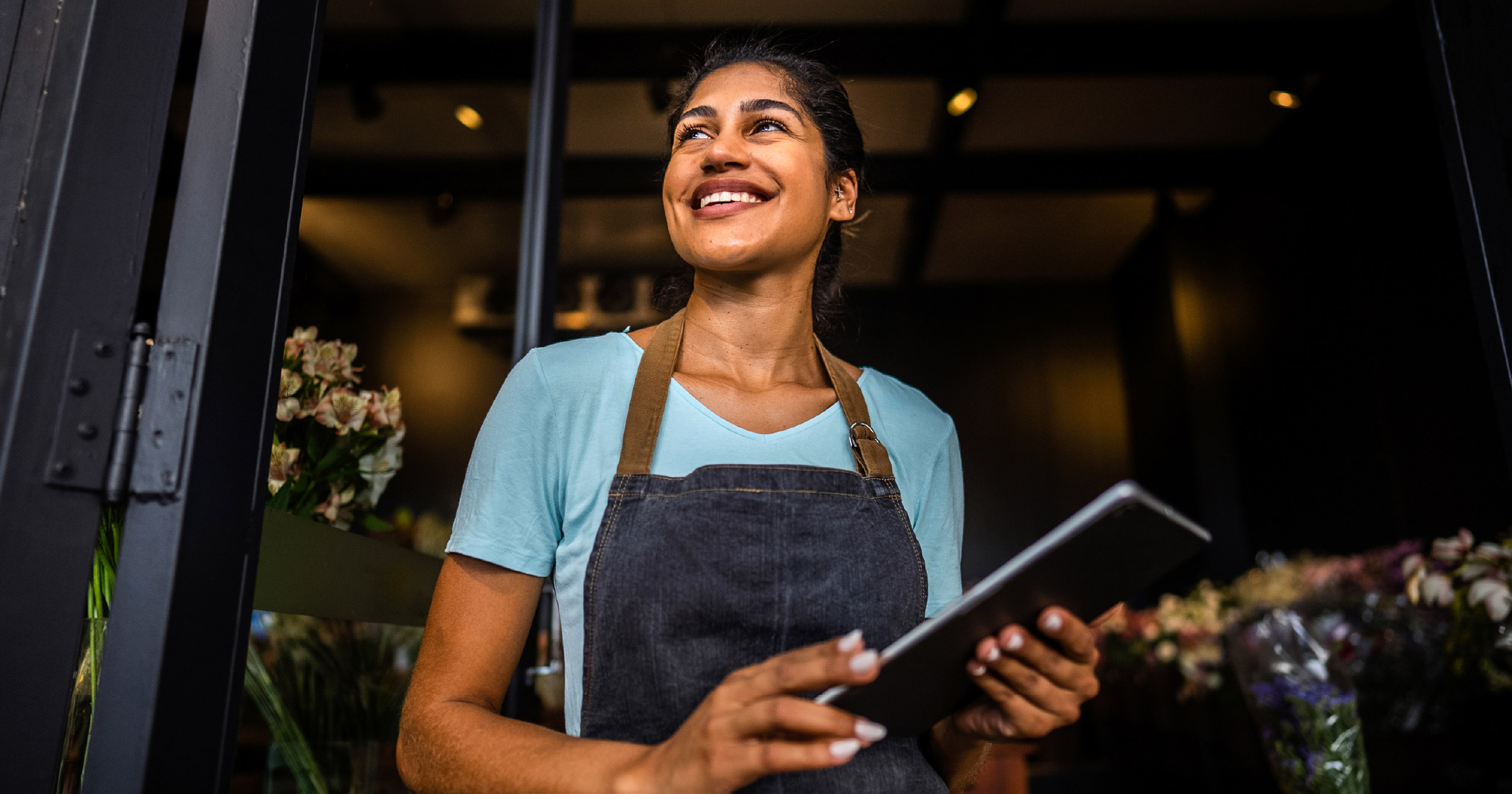 Small business owner managing community marketing via mobile app